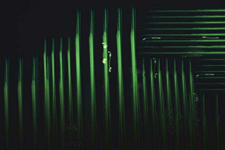 Abstract glowing green vertical lines on a dark background